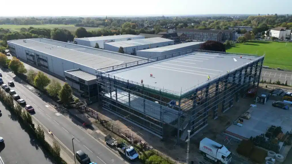 Aerial view of large warehouse under construction.